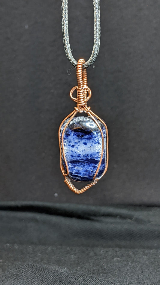 Hand Cut Sodalite Wire Wrapped Pendant.